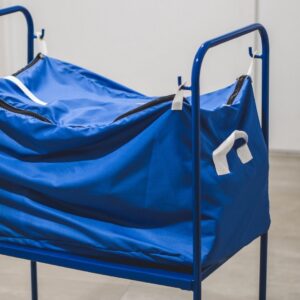 Metal RTP Radom transport cart equipped with a blue, zippered textile bag, used in professional laundry logistics.